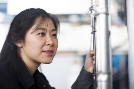 Technician operating machine in factoryの写真素材