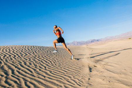 Runner sprinting in desert, Death Valley, California, USAの写真素材