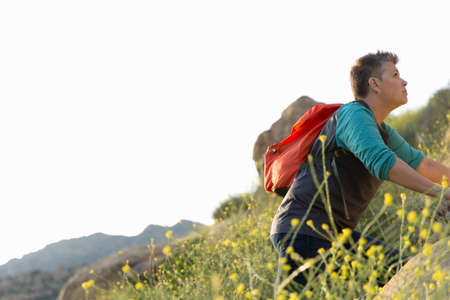 Woman hiker climbing up hill