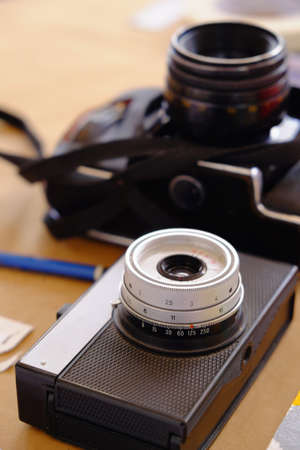 Two traditional camera's on table