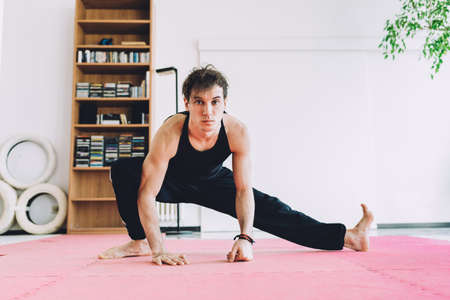 Man in martial art stance looking at camera