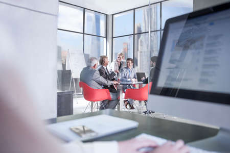 Businessmen meeting at conference table, New York, USAの写真素材