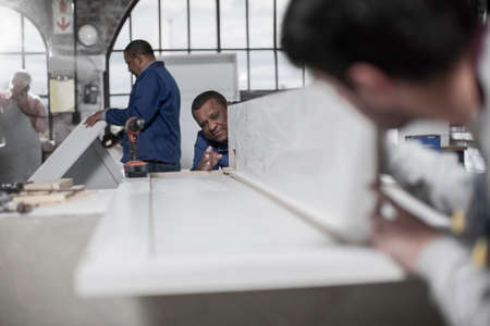 Carpenters checking product in wood workshop