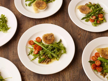 Plates of peppered fried goats cheese and salad
