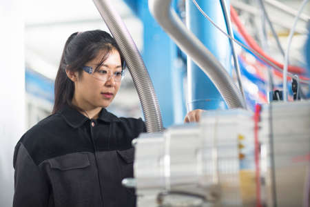 Technician operating machine in factory
