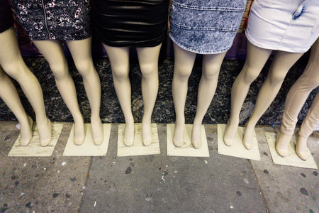 Detail of six female dummies on sidewalk wearing mini skirtsの写真素材