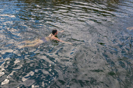 Young woman swimming in sea, elevated viewの写真素材