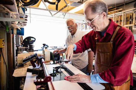 Senior men working with carpentry equipment workshopの写真素材
