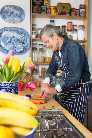 Man preparing food in kitchenの写真素材