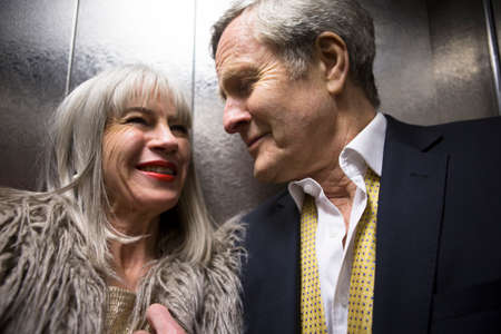 Couple dressed up, in liftの写真素材