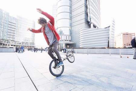 BMX Biker doing stunt in urban areaの写真素材