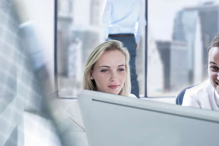 Businessman and businesswoman working with computers in officeの写真素材