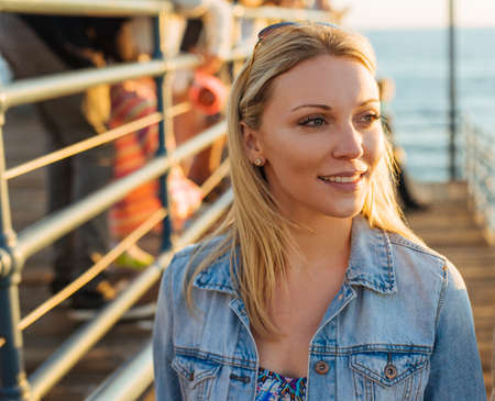 Beautiful young blond woman on pier, Santa Monica, California, USA