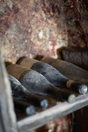 Row of vintage bottles of wine in Hungarian wine cellar