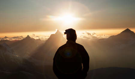 Climber watching the Matterhorn at sunset, Zermatt, Canton Wallis, Switzerland