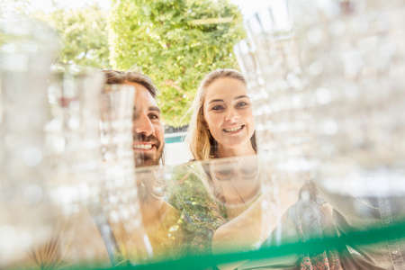 Young couple looking at drinking glasses through shop window, Franschhoek, South Africa