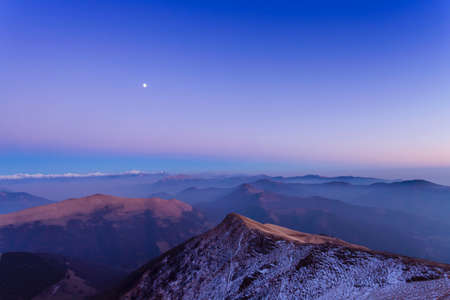 Elevated snow capped mountain landscape with valley mist at dawn, Monte Generoso,Ticino, Switzerlandの写真素材