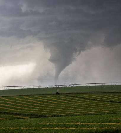 Large tornado descends over farmlandの写真素材
