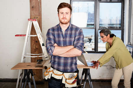 Carpenter, arms crossed looking at cameraの写真素材