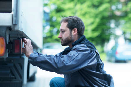 Man adjusting truck control panelの写真素材