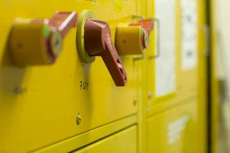 Close up of levers on yellow control panel