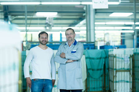 Colleagues in launderette looking at camera smilingの写真素材