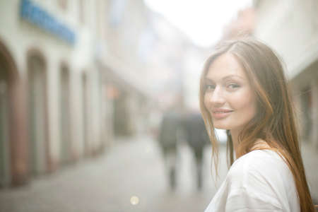 Portrait of beautiful woman on city street, Freiburg, Germanyの写真素材