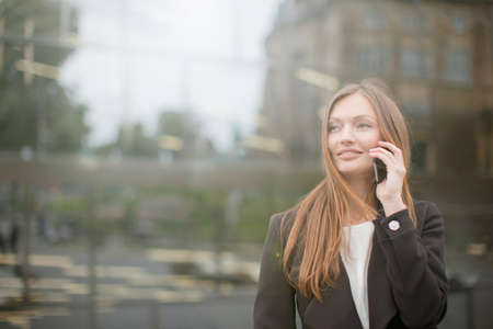 Businesswoman talking on smartphone, Freiburg, Germanyの写真素材