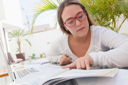 Teenage girl with text books studying