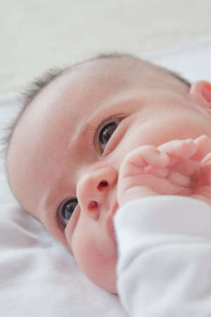 Head shot of baby boy lying downの写真素材