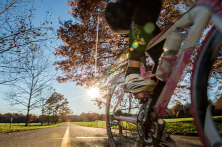 Cropped view of cyclist cycling in sunlightの写真素材