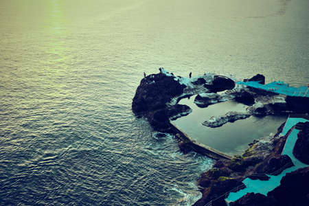 Elevated view of rocky pier in ocean, Madeira, Funchal, Portugalの写真素材