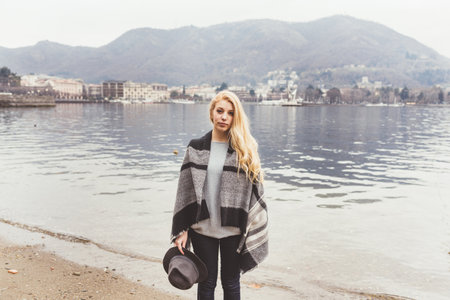 Portrait of stylish young woman on lakeside, Lake Como, Italy