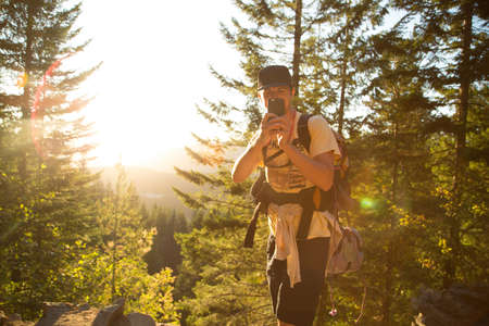 Male hiker taking smartphone selfie on forest ridge, Mount Hood National Forest, Oregon, USAの写真素材