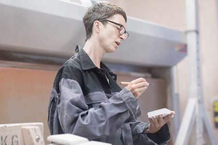 Stonemason writing in notebook