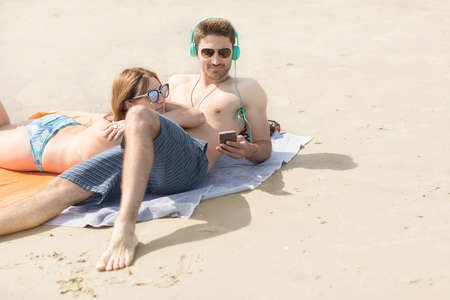 Couple relaxing on beach, Coney island, Brooklyn, New York, USAの写真素材