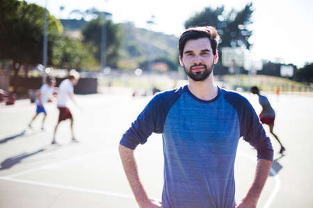 Portrait of young man on basketball court