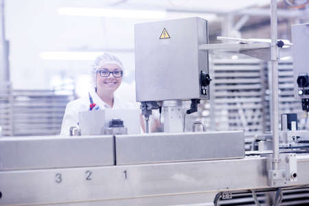 Factory worker operating food production machinery