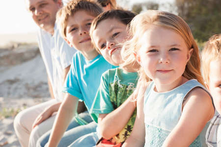 Family at beach looking at camera smilingの写真素材