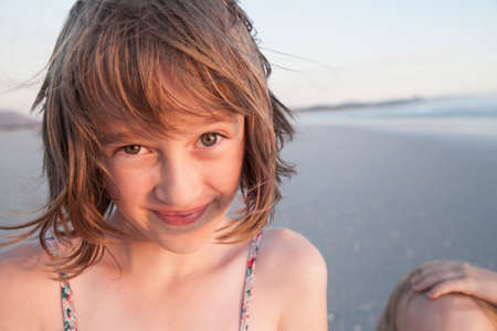 Portrait of girl on beach looking at camera smilingの写真素材