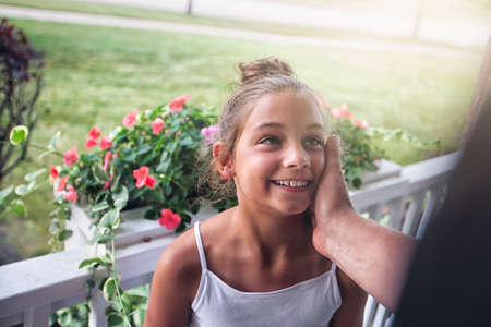 Father touching smiling daughters cheekの写真素材