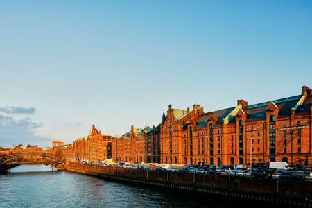 Old warehouses on waterfront at sunset, Hafencity, Hamburg, Germanyの写真素材