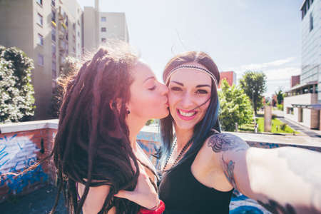 Young woman kissing friend on cheek