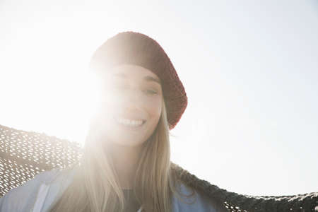 Young woman in beret enjoying sunny dayの写真素材