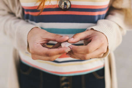 Woman holding seashellの写真素材