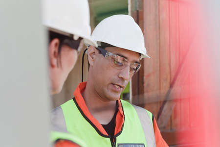 Engineers in discussion on oil rig