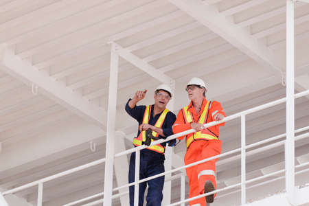 Engineers in discussion on oil rigの写真素材