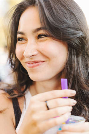 Young woman holding cold drinkの写真素材