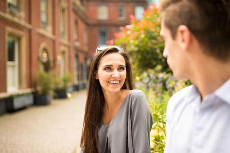 Young businesswoman and man talking outside office, London, UKの写真素材