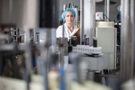 Lab technician checking equipment at packaging factory lab